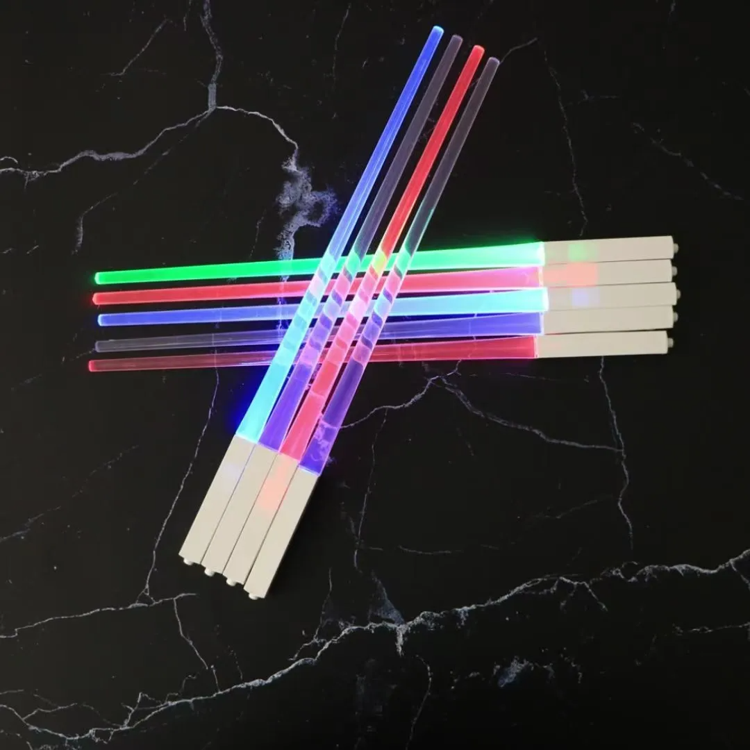 Set of glow sticks with colored ends on a black textured background